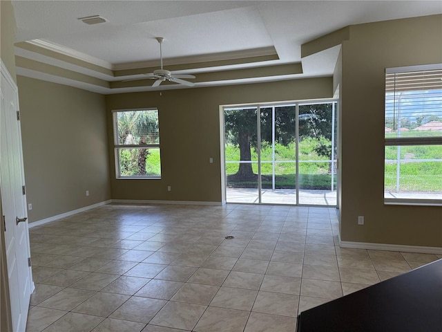 2760 Royal Palm Dr, North Port, FL 34288 - spare room with a raised ceiling, healthy amount of natural light, a ceiling fan, light tile patterned flooring, and ornamental molding