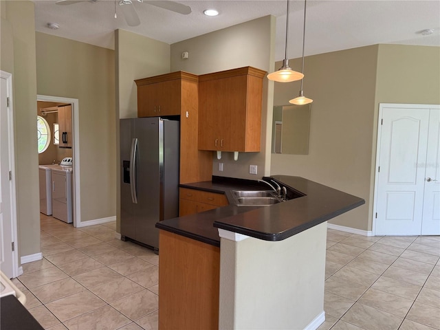 2760 Royal Palm Dr, North Port, FL 34288 - kitchen featuring stainless steel fridge with ice dispenser, dark countertops, separate washer and dryer, a peninsula, and a ceiling fan