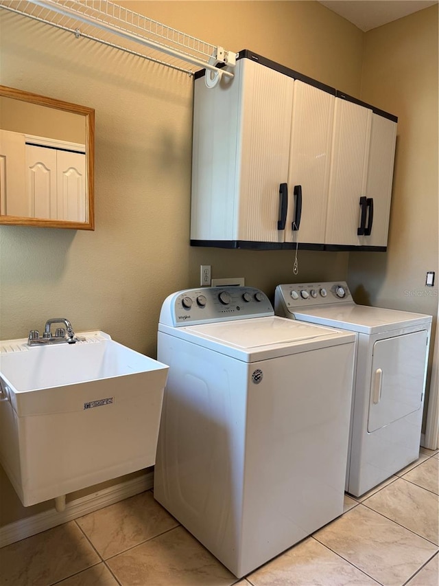 2760 Royal Palm Dr, North Port, FL 34288 - laundry room featuring cabinet space, washer and clothes dryer, and light tile patterned flooring