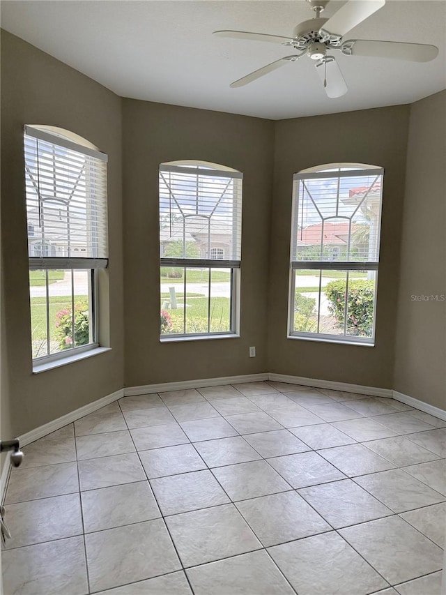 2760 Royal Palm Dr, North Port, FL 34288 - unfurnished room featuring plenty of natural light, light tile patterned floors, and a ceiling fan