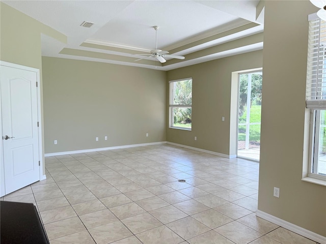 2760 Royal Palm Dr, North Port, FL 34288 - empty room featuring ceiling fan, light tile patterned floors, a tray ceiling, and crown molding