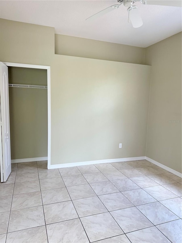 2760 Royal Palm Dr, North Port, FL 34288 - unfurnished bedroom featuring a closet, a ceiling fan, and light tile patterned floors