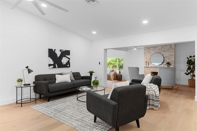 11772 96th Pl, Seminole, FL 33772 - living area featuring ceiling fan, light wood finished floors, recessed lighting, a large fireplace, and lofted ceiling