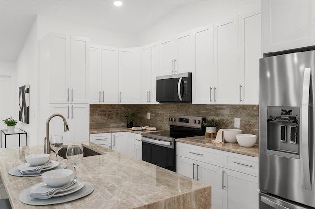11772 96th Pl, Seminole, FL 33772 - kitchen featuring stainless steel appliances, backsplash, white cabinets, light stone counters, and recessed lighting