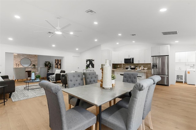 11772 96th Pl, Seminole, FL 33772 - dining area featuring vaulted ceiling, light wood-type flooring, washer / clothes dryer, ceiling fan, and recessed lighting