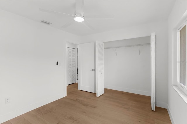 11772 96th Pl, Seminole, FL 33772 - unfurnished bedroom featuring wood finished floors, a closet, and a ceiling fan