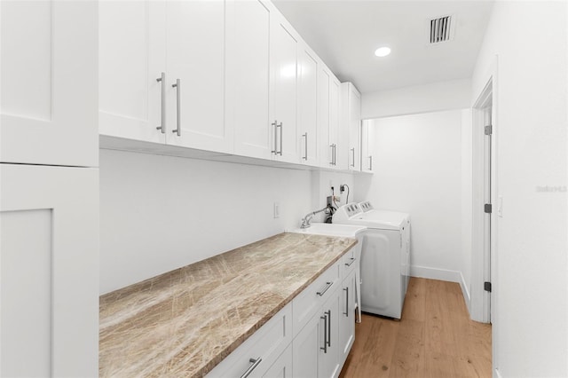 11772 96th Pl, Seminole, FL 33772 - laundry area featuring cabinet space, light wood-type flooring, washing machine and clothes dryer, and recessed lighting