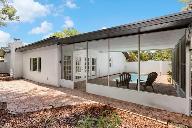 11772 96th Pl, Seminole, FL 33772 - back of house with a patio, french doors, a chimney, and stucco siding