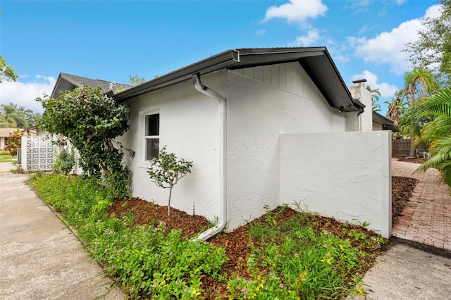 11772 96th Pl, Seminole, FL 33772 - view of property exterior featuring stucco siding and a chimney