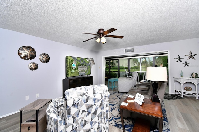 3 Pirates Ln Unit 32A, Punta Gorda, FL 33955 - living room with ceiling fan, wood finished floors, and a textured ceiling
