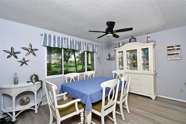 3 Pirates Ln Unit 32A, Punta Gorda, FL 33955 - dining area featuring light wood finished floors, a textured ceiling, and a ceiling fan