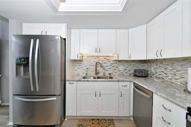 3 Pirates Ln Unit 32A, Punta Gorda, FL 33955 - kitchen with appliances with stainless steel finishes, decorative backsplash, and white cabinets