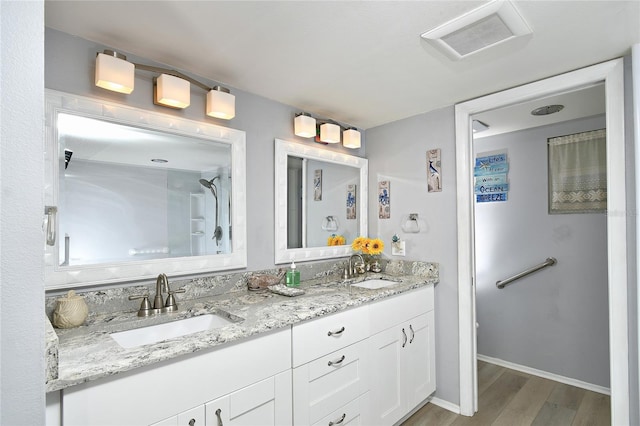 3 Pirates Ln Unit 32A, Punta Gorda, FL 33955 - full bathroom with wood finished floors, double vanity, and a shower
