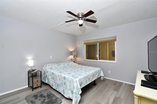 3 Pirates Ln Unit 32A, Punta Gorda, FL 33955 - bedroom featuring wood finished floors, a textured ceiling, and a ceiling fan