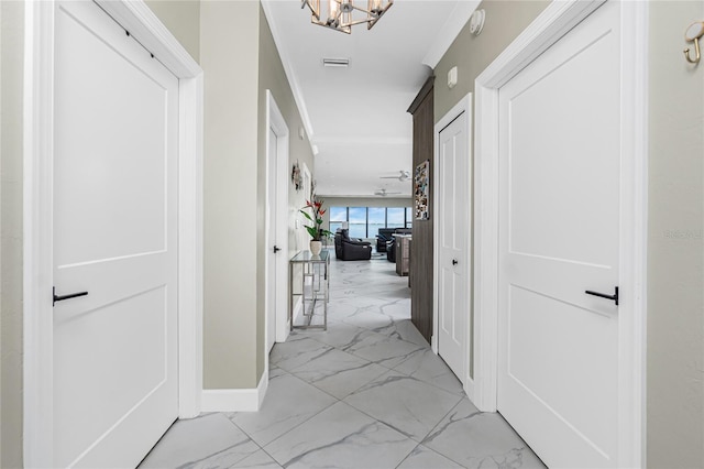 1750 Jamaica Way Unit 131, Punta Gorda, FL 33950 - hallway featuring light marble finish floors and a chandelier