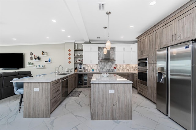 1750 Jamaica Way Unit 131, Punta Gorda, FL 33950 - kitchen with stainless steel appliances, wall chimney exhaust hood, a peninsula, light marble finish flooring, and a kitchen bar