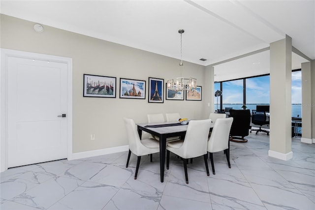 1750 Jamaica Way Unit 131, Punta Gorda, FL 33950 - dining room featuring a chandelier, light marble finish floors, and a wall of windows
