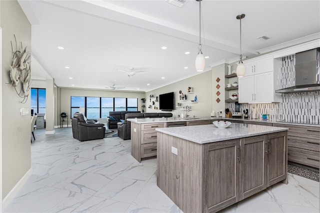 1750 Jamaica Way Unit 131, Punta Gorda, FL 33950 - kitchen featuring wall chimney range hood, light marble finish flooring, backsplash, a kitchen island, and black electric stovetop