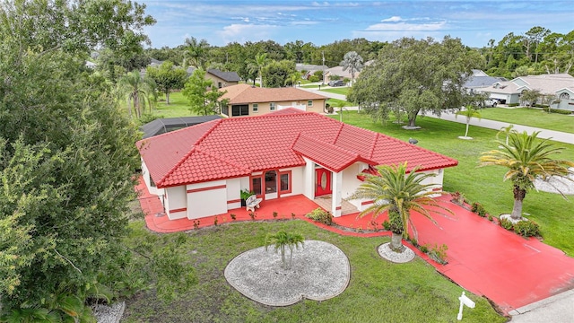 25499 Taltal Dr, Punta Gorda, FL 33983 - view of front of house featuring a tile roof, a front yard, stucco siding, and a residential view
