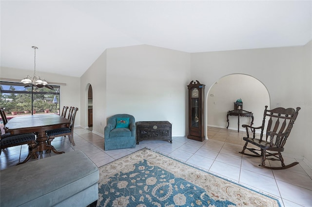 25499 Taltal Dr, Punta Gorda, FL 33983 - living room featuring arched walkways, lofted ceiling, tile patterned floors, and a chandelier