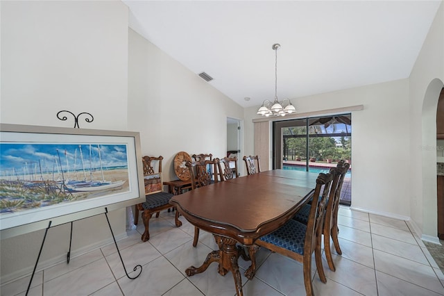 25499 Taltal Dr, Punta Gorda, FL 33983 - dining area featuring arched walkways, a chandelier, light tile patterned floors, and high vaulted ceiling