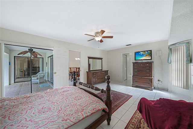25499 Taltal Dr, Punta Gorda, FL 33983 - bedroom with light tile patterned floors, a textured ceiling, and a ceiling fan