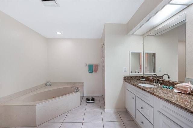 25499 Taltal Dr, Punta Gorda, FL 33983 - bathroom featuring a garden tub, vanity, and tile patterned floors