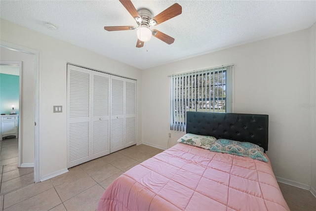 25499 Taltal Dr, Punta Gorda, FL 33983 - bedroom featuring a closet, tile patterned floors, ceiling fan, and a textured ceiling