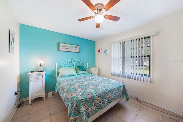 25499 Taltal Dr, Punta Gorda, FL 33983 - bedroom featuring tile patterned floors, a textured ceiling, and a ceiling fan