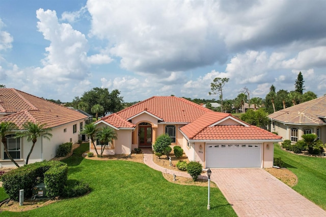 1855 Silver Palm Rd, North Port, FL 34288 - mediterranean / spanish-style house featuring french doors, a tiled roof, an attached garage, stucco siding, and a front yard