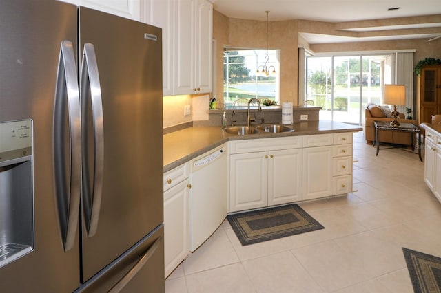 1855 Silver Palm Rd, North Port, FL 34288 - kitchen featuring stainless steel fridge, white dishwasher, white cabinets, open floor plan, and light tile patterned flooring