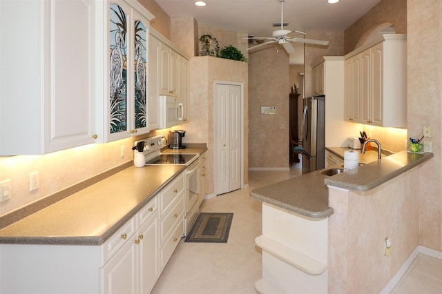 1855 Silver Palm Rd, North Port, FL 34288 - kitchen with white appliances, a ceiling fan, light tile patterned flooring, recessed lighting, and a peninsula