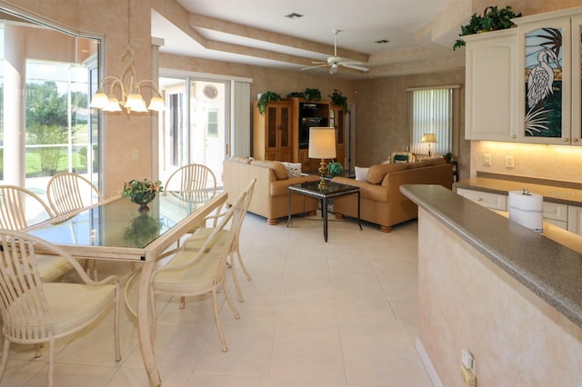 1855 Silver Palm Rd, North Port, FL 34288 - dining area featuring a chandelier, ceiling fan, light tile patterned floors, and a tray ceiling
