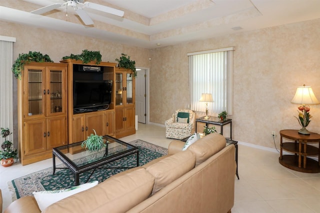 1855 Silver Palm Rd, North Port, FL 34288 - living room featuring light tile patterned flooring, a ceiling fan, and a tray ceiling