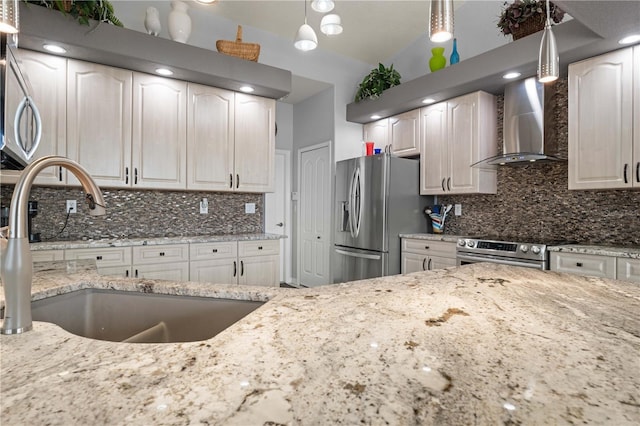 1422 Via Milanese, Punta Gorda, FL 33950 - kitchen with wall chimney range hood, appliances with stainless steel finishes, light stone counters, and decorative backsplash