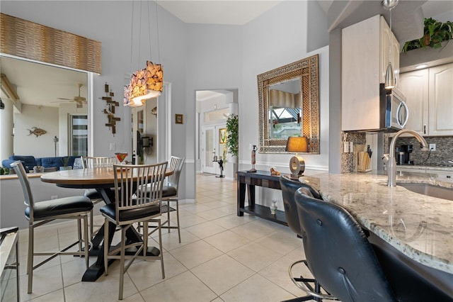 1422 Via Milanese, Punta Gorda, FL 33950 - dining area featuring a high ceiling, light tile patterned flooring, and a ceiling fan