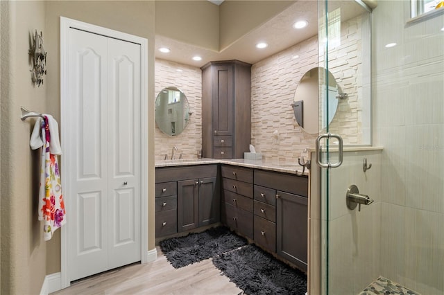 1422 Via Milanese, Punta Gorda, FL 33950 - full bathroom featuring double vanity, wood finished floors, a shower stall, and recessed lighting