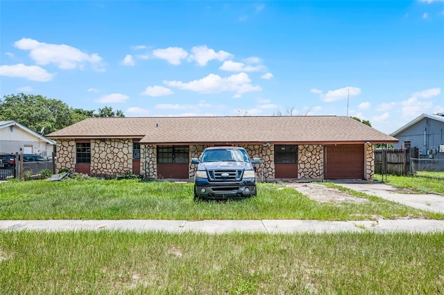 3207 Chariot Pl, Orlando, FL 32818 - ranch-style house featuring stone siding, driveway, roof with shingles, and an attached garage