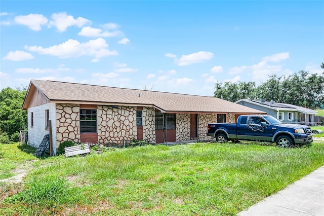 3207 Chariot Pl, Orlando, FL 32818 - ranch-style house with stone siding and roof with shingles