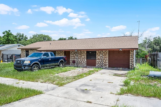 3207 Chariot Pl, Orlando, FL 32818 - single story home with stone siding, concrete driveway, a garage, and a shingled roof