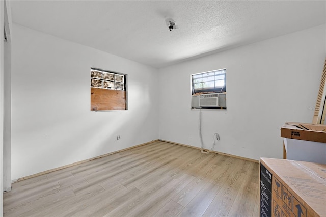 3207 Chariot Pl, Orlando, FL 32818 - empty room with cooling unit, light wood-type flooring, and a textured ceiling