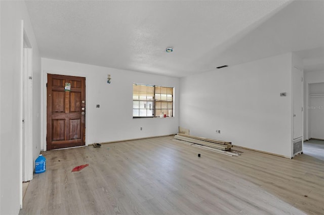 3207 Chariot Pl, Orlando, FL 32818 - unfurnished living room featuring wood finished floors and a textured ceiling