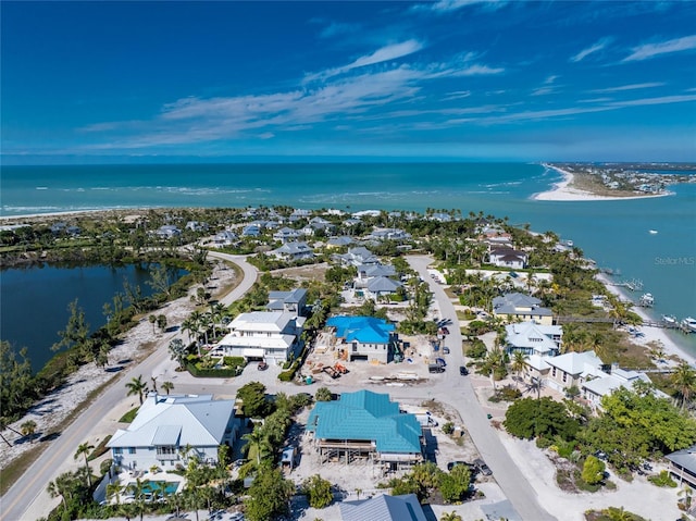 aerial view with a water view and a beach view