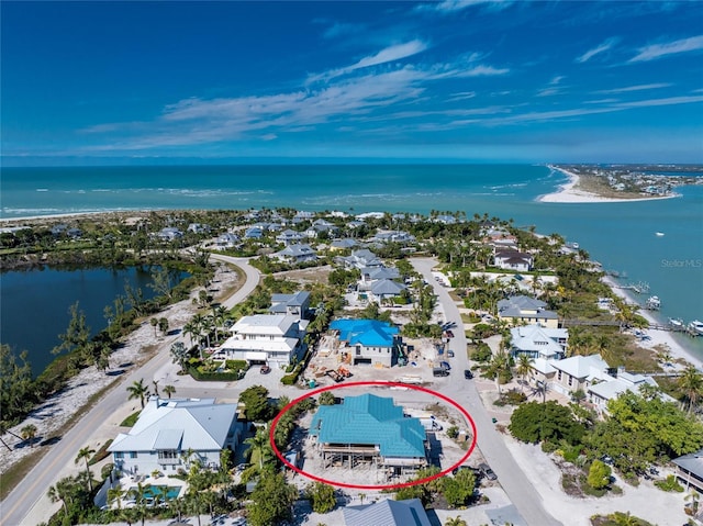 drone / aerial view with a water view and a view of the beach