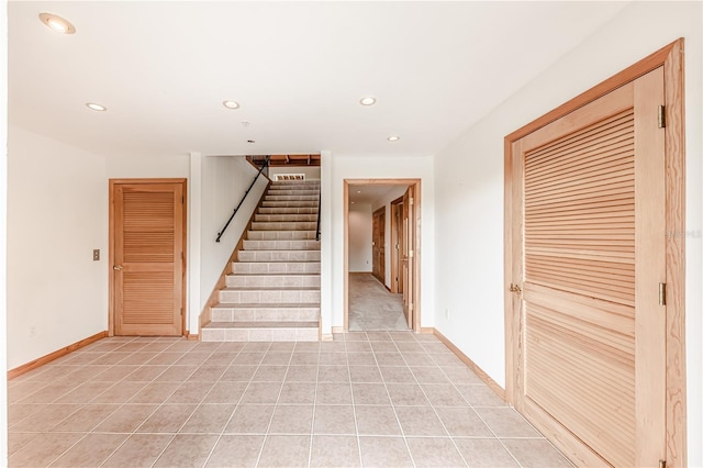 staircase with light tile patterned floors