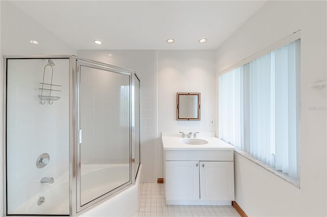 bathroom featuring vanity, combined bath / shower with glass door, and tile patterned flooring