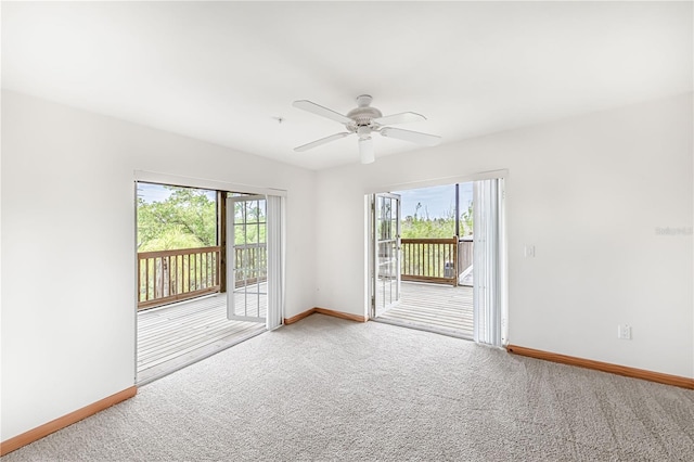 carpeted empty room with a healthy amount of sunlight and ceiling fan