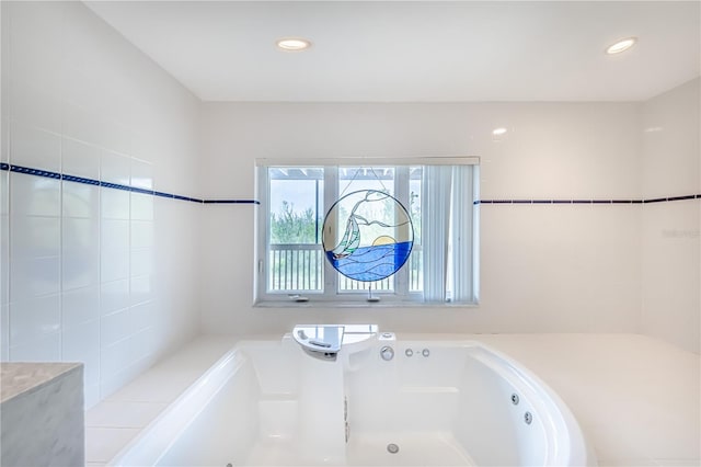 bathroom featuring a relaxing tiled tub