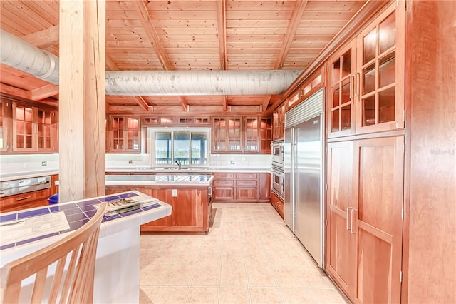 kitchen with stainless steel built in refrigerator, beam ceiling, light tile patterned floors, and wood ceiling