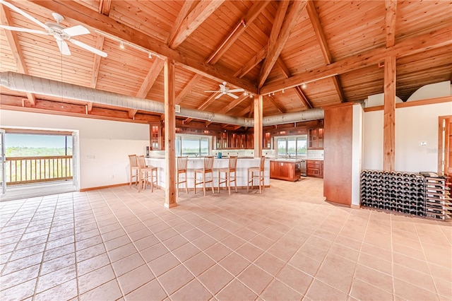 unfurnished living room with plenty of natural light, light tile patterned floors, and ceiling fan